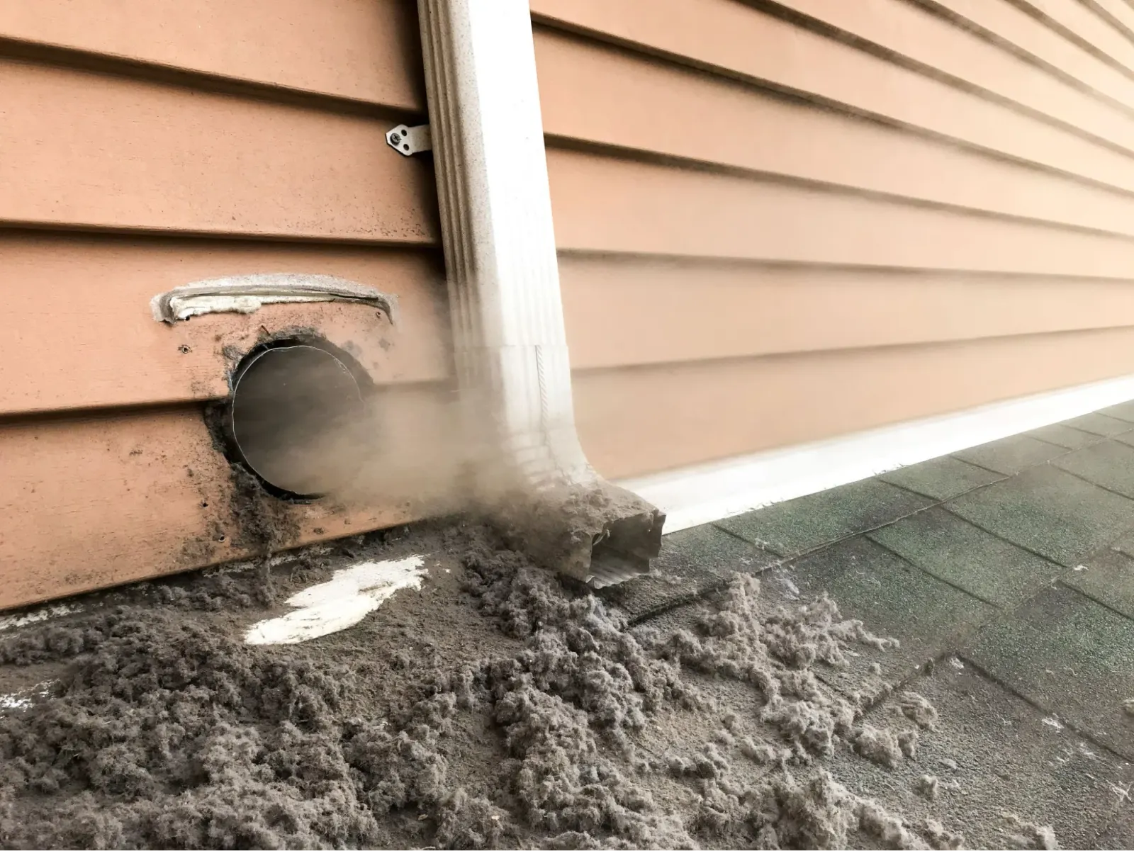 Heavy lint buildup restricting airflow inside a dryer vent